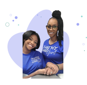 two girls holding hands and smiling